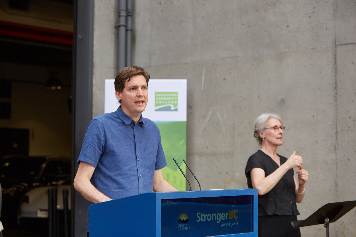 Vancouver corporate event photograph of press announcement with BC Premier and sign language interpreter at the podium