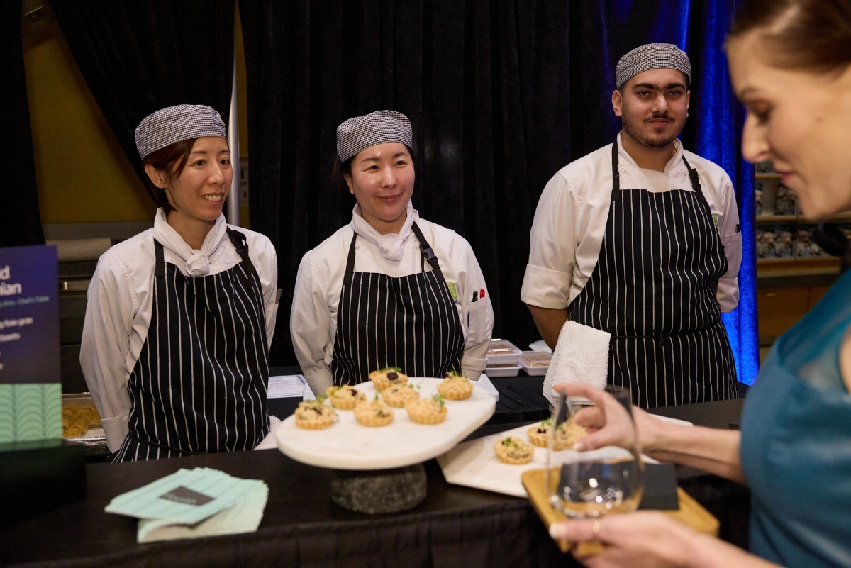 corporate-event-photograph-female-guest-food-station-chefs