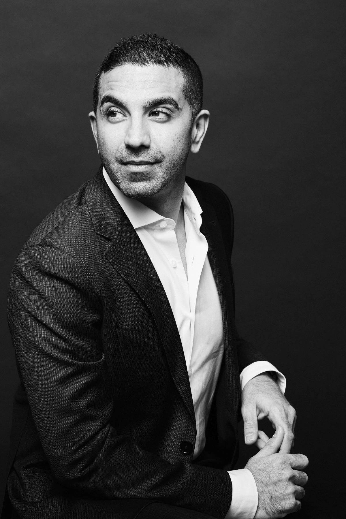 Professional corporate headshot in black and white of male executive looking away from camera taken in Vancouver photography studio