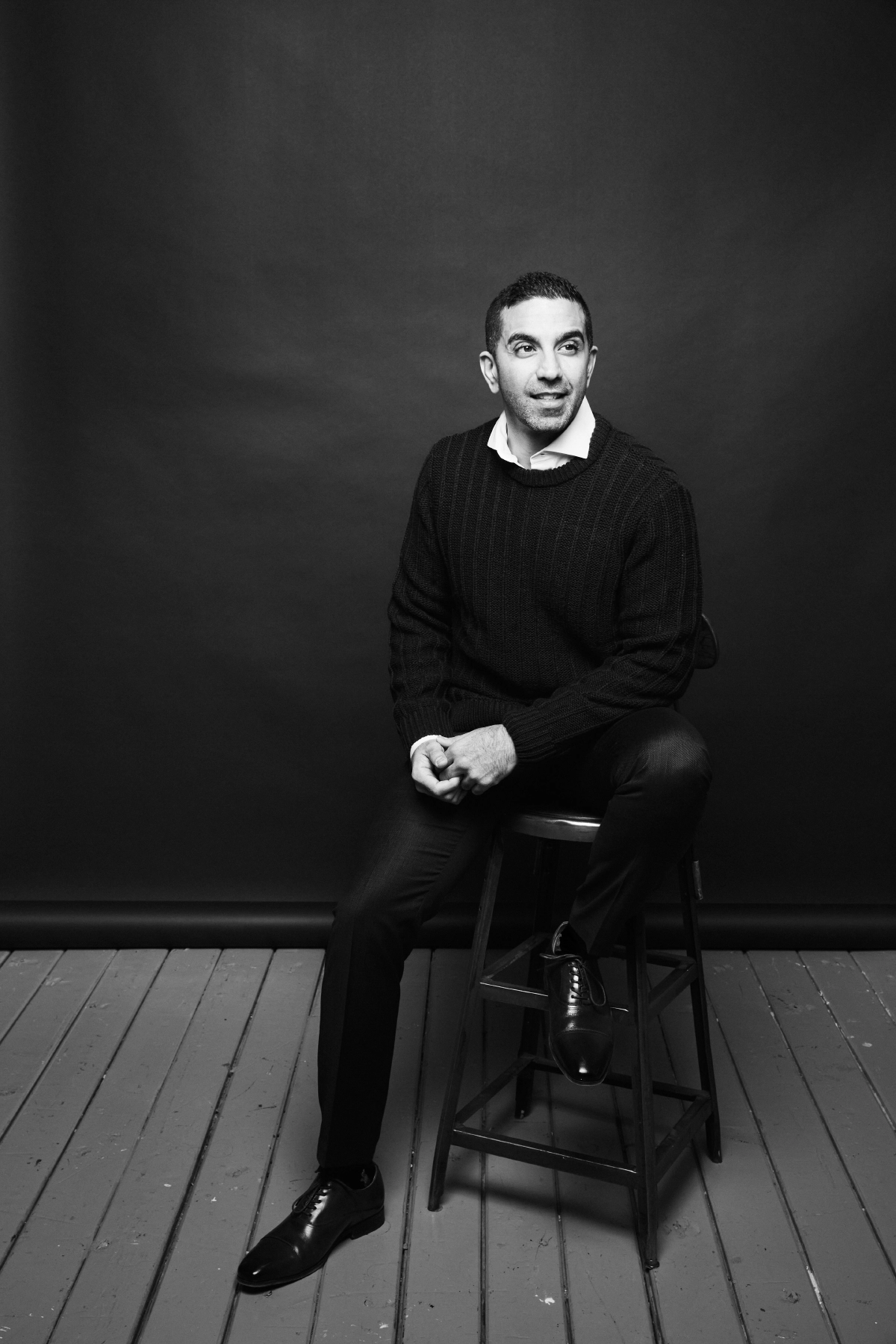 Professional black and white portrait of male executive sitting