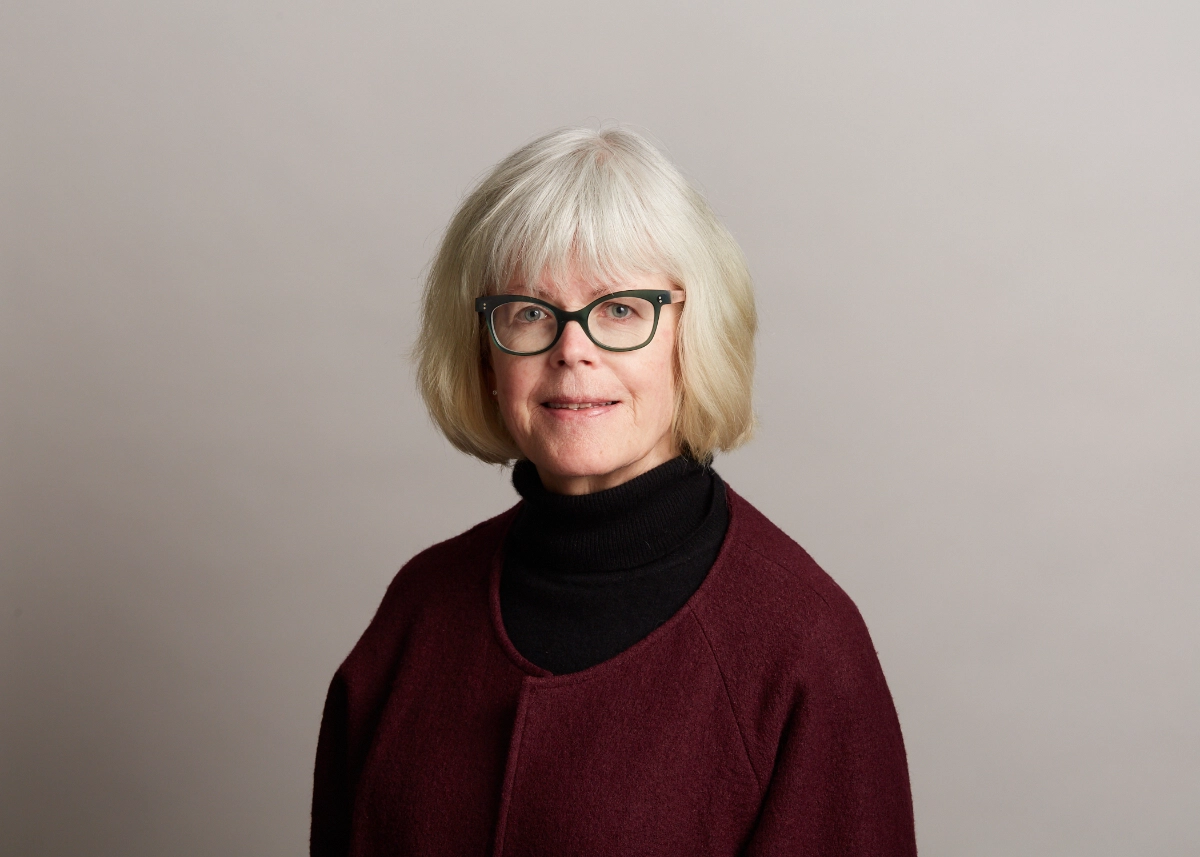 North Vancouver corporate headshot of female partner in a red jacket and glasses