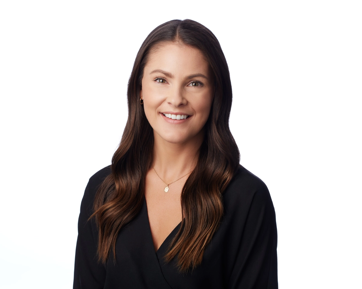 Vancouver corporate headshot of female with brown hair and a black top of a white backgroun