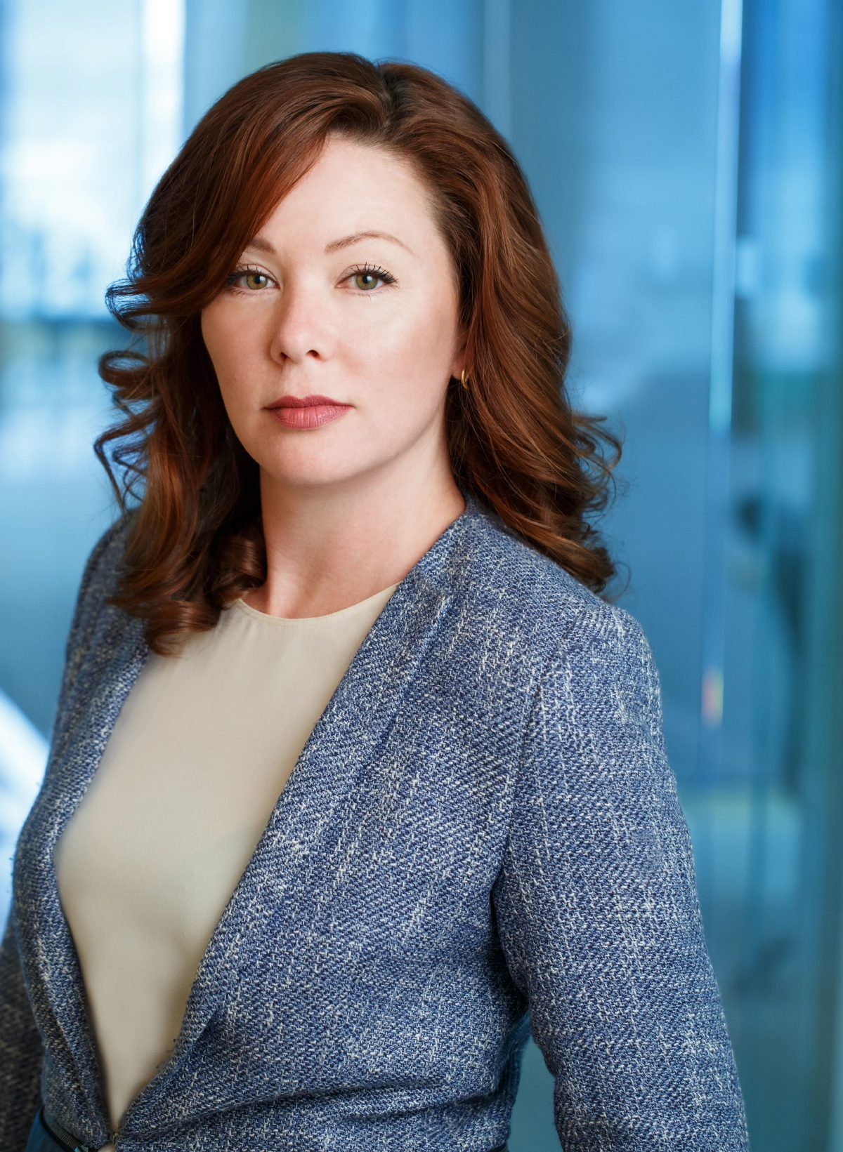 professional photograph of female vancouver lawyer with a window view background taken in a vancouver office